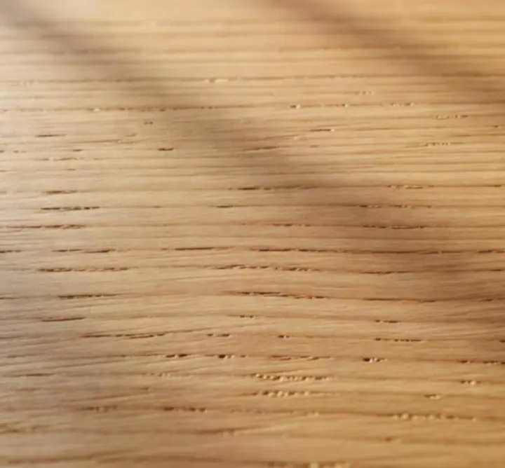 Close-up detail of natural hardwood grain showing organic texture and warm wood tones