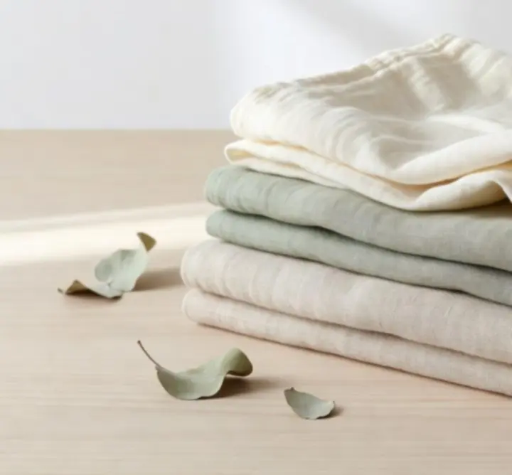 Organic cotton muslin and European flax linen fabrics in natural cream and sage tones
