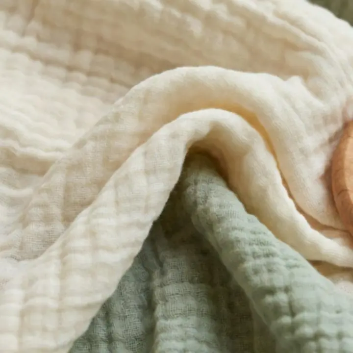 Close-up detail of organic cotton textile texture showing natural weave